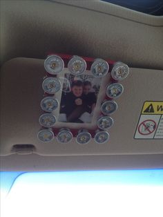 a car dashboard with an electronic device attached to the dash board and buttons on it