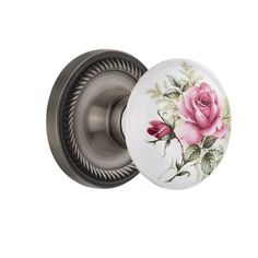 a door knob with a pink rose painted on the front and back of it's cover