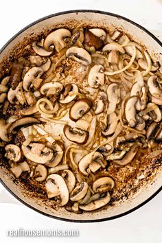 a pan filled with cooked mushrooms on top of a table