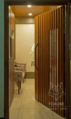 an open door leading into a room with wood slats on the walls and floor