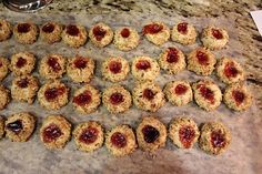 cookies with jam are arranged on a counter