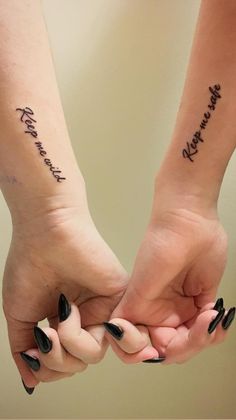 two people holding hands with tattoos on their arms that say, you're the best