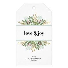 the love and joy gift tag is shown on a white background with green leaves, red berries