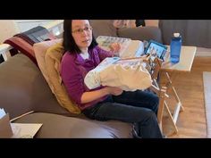 a woman sitting on top of a brown couch