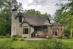 a house in the middle of some trees and grass