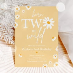 a yellow birthday card with daisies and the words wild one written in white on it