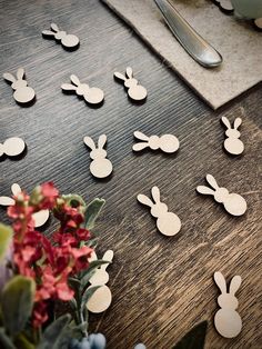 the table is covered with wooden cutouts for easter bunnies and bunny ears on them