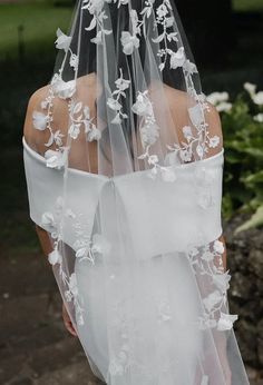 a woman wearing a veil with flowers on it