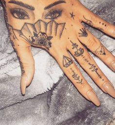 a woman's hand with tattoos on it