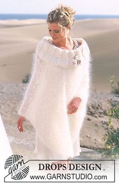 a woman is walking on the beach wearing a white sweater and heels with her hand in her pocket