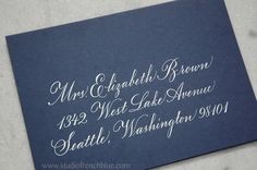 a close up of a blue envelope with white ink