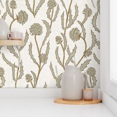 a white shelf with two vases on top of it next to a wallpaper