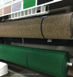 the carpet is green and has several different color options on it, along with some white bins