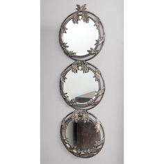 three circular mirrors hanging on the wall