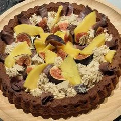 a chocolate cake topped with fruit and nuts