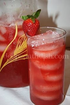 two glasses filled with red liquid and strawberries