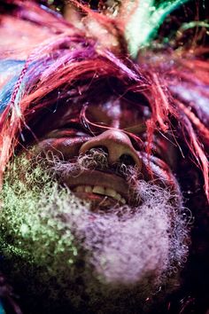 a man with long hair and beard covered in colored powder