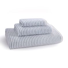 three towels stacked on top of each other in front of a white background with blue stripes