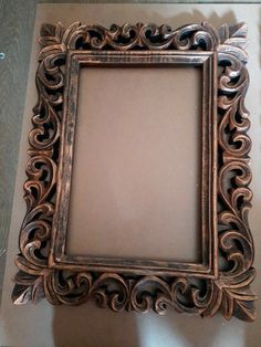 an ornate silver frame sitting on top of a table