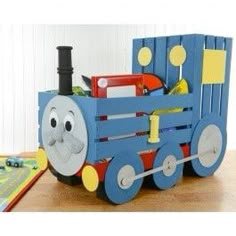 a wooden toy train with a face on it