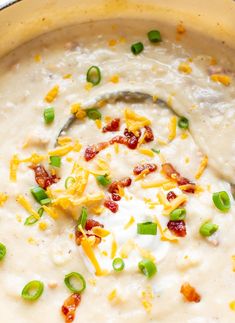 a bowl filled with cheese and green onions