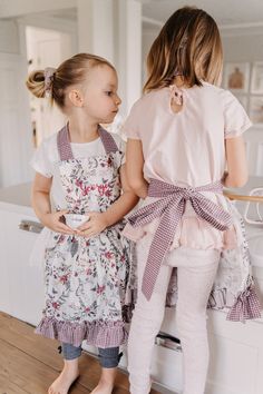 Mommy and me bunny and blooms aprons!This handcrafted apron is made with an adorable berry blooms and sketched bunnies cotton fabric that features beautiful florals in a rich berry color and sage greens. The neck strap, belt and ruffle are made with a coordinating berry gingham cotton fabric. The apron is finished off with custom embroidery in your little chef's name (embroidered above is the burgundy).The aprons are available in four child sizes ranging from XS to Large. Please see the size cha Berry Color, Personalized Aprons, Fashion Closet, Kids Ideas, Custom Embroidery, Neck Strap, Mommy And Me, Gingham, Berry