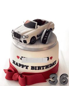 a birthday cake with two cars on top