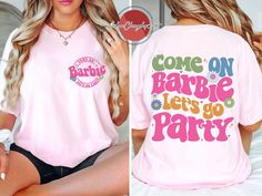 a woman wearing a pink shirt that says come on barbie let's go party