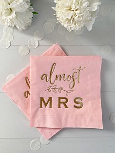 two pink napkins that say almost mrs and have gold foil lettering on the front