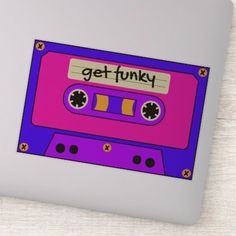 a purple and pink cassette tape with the words get funky on it's side