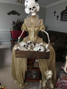 a skeleton sitting on top of a table filled with skulls