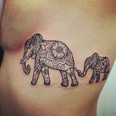 an elephant tattoo is shown on the side of a woman's stomach, which features intricate designs