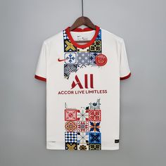 a white and red shirt with an all across design on the front, hanging from a wooden hanger