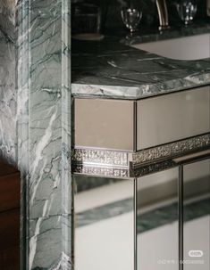 a marble counter top in a bathroom next to a sink