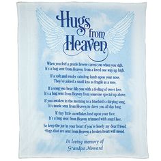 a blue and white towel with an angel's wings in the center that says hugs from heaven