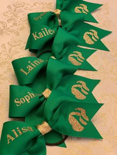 green and gold ribbon with monogrammed names on it