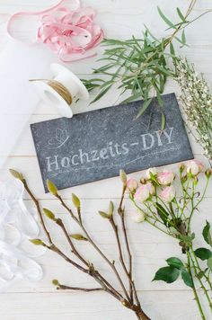 flowers and ribbon on a table with a sign that says hoczets - diy