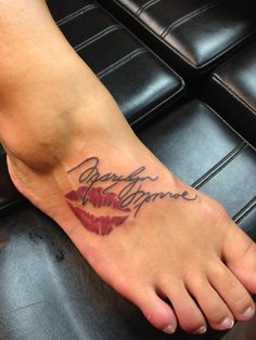 a woman's foot with a tattoo that says marilyn monroe on it and the words marilyn monroe written in cursive font