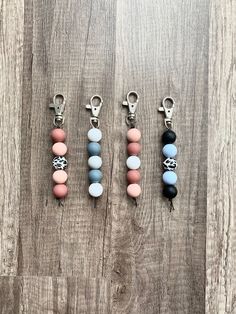 four key chains with different colored beads on them