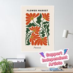 a flower market poster hanging on the wall above a desk