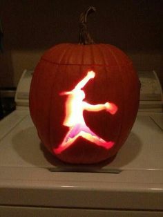 a pumpkin carved to look like a basketball player