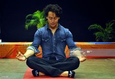 a man sitting in the middle of a yoga pose