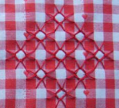 red and white checkered tablecloth with small circles on it's edges, which are stitched together