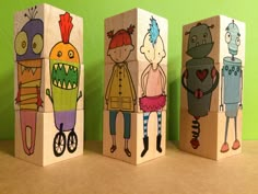 three wooden blocks with cartoon characters painted on them