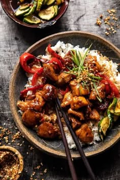 two bowls filled with food and chopsticks next to each other on a table