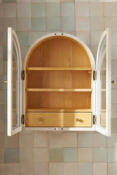 a cabinet with two open doors and drawers