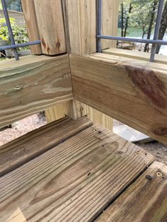 a wooden bench sitting next to a metal railing