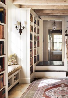 a room filled with lots of books on top of a book shelf next to a doorway