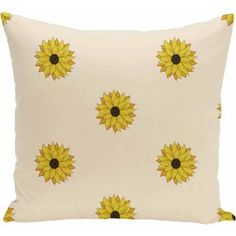 a yellow and white pillow with sunflowers on it