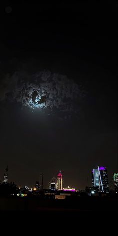 the moon is shining brightly in the night sky over a cityscape with skyscrapers